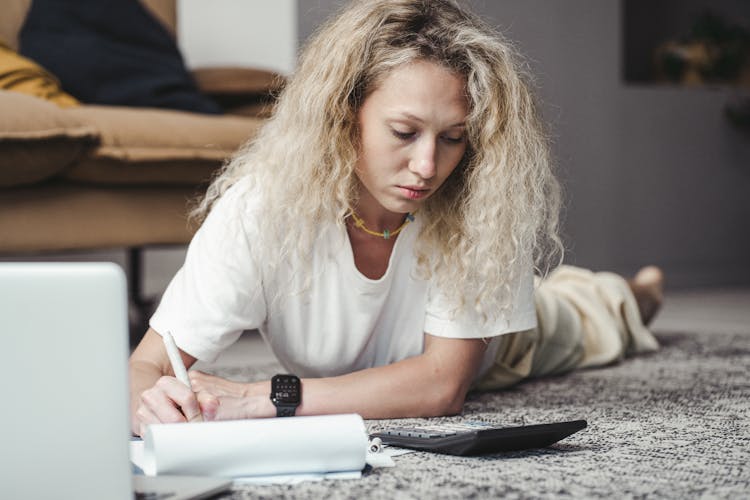 A Woman On The Floor Making Computation