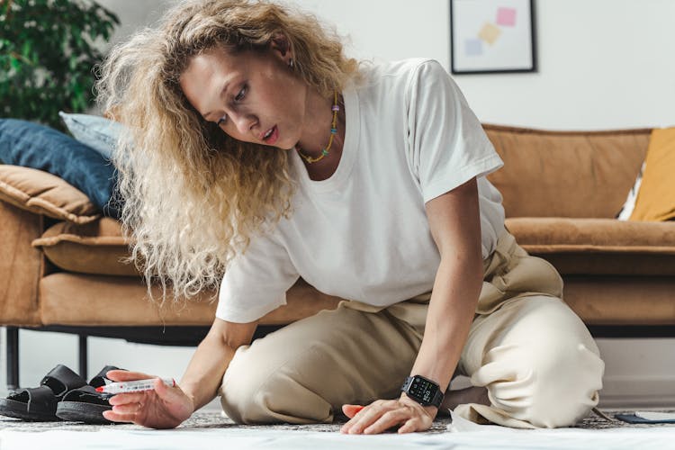 Woman With Curly Hair Working On The Floor