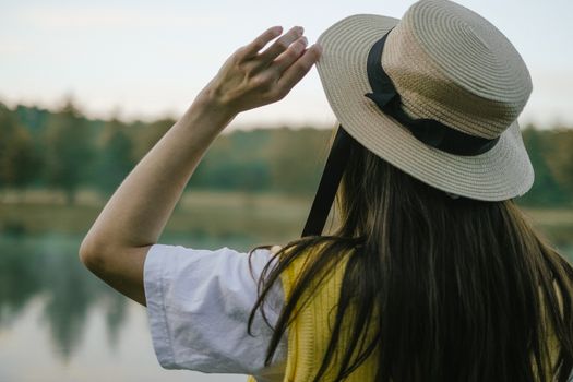 Back View of a Person Wearing Straw Boater Hat 