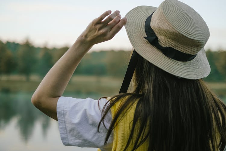 Back View Of A Person Wearing Straw Boater Hat 