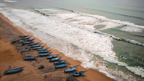 Blue Wooden Boats on Seashore