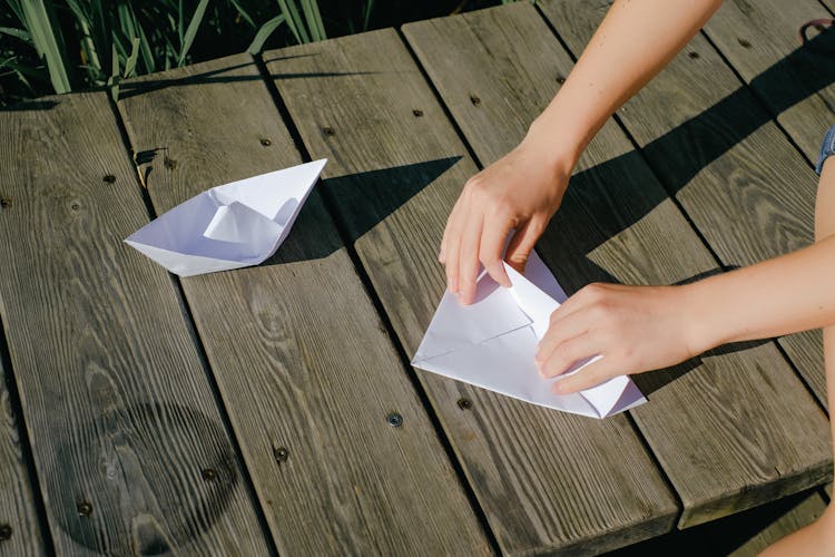 Person Making A Paper Boat 