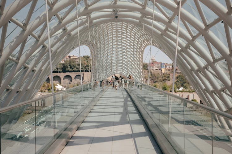 People Walking On Concrete Bridge