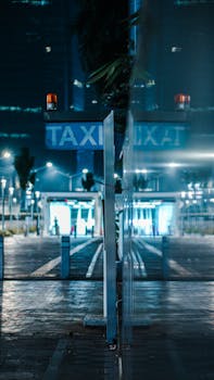 Moody night reflection of taxi sign in Jakarta street with urban lighting.
