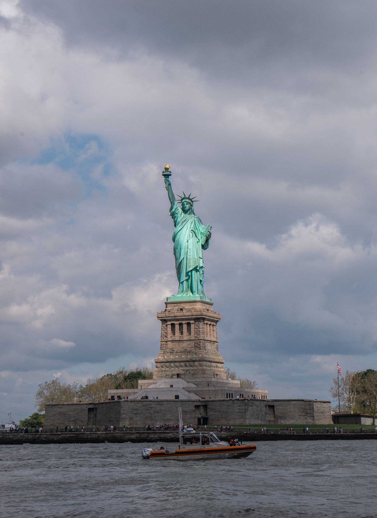 Tour boat passing close by the Statue of Liberty