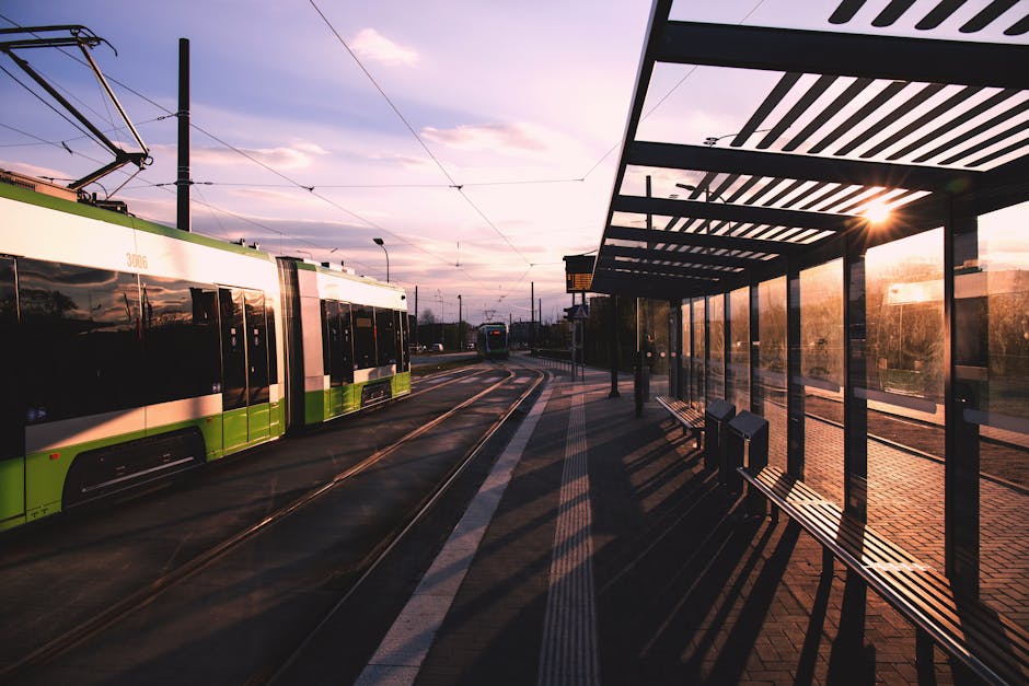 Green and White Train Near Train Terminal during Daytime