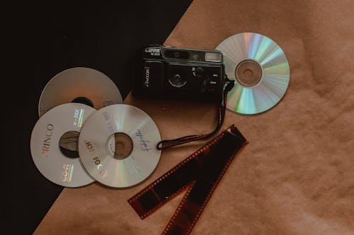 Free Discs Beside an Analog Camera Stock Photo
