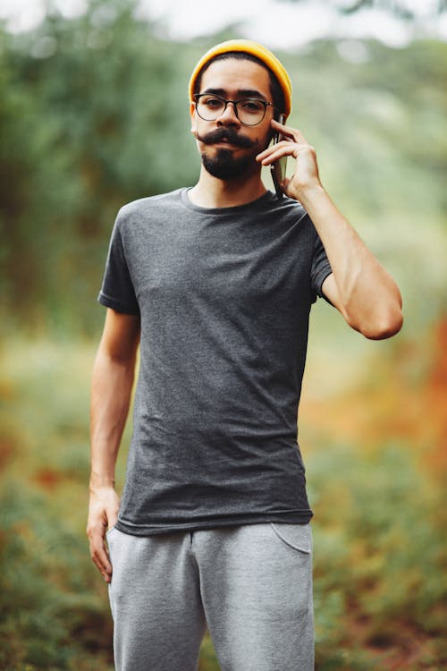 A Bearded Man Talking on the Phone 