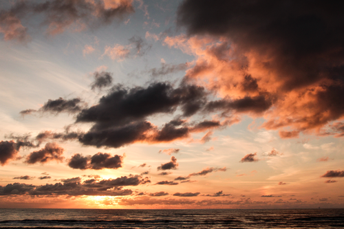 Free Stunning sunset with dramatic clouds over the ocean at Noordwijk, Netherlands. Stock Photo