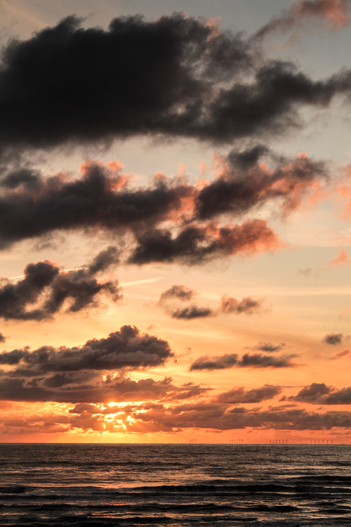 Free Breathtaking view of a dramatic sunset over the ocean at Noordwijk, Netherlands. Stock Photo
