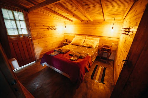 Free A Bedroom in a Wooden Cabin Stock Photo