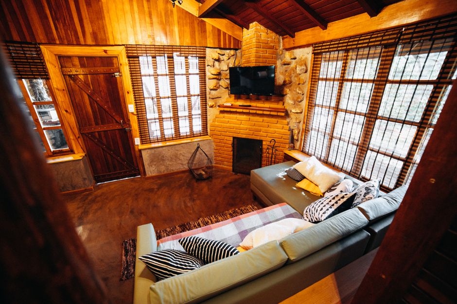 cozy log cabin interior with stone fireplace - log cabin homes for sale cozy log cabin interior with stone fireplace - log cabin homes for sale