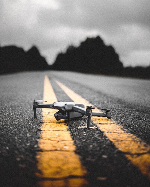 Gray Drone Camera on the Road