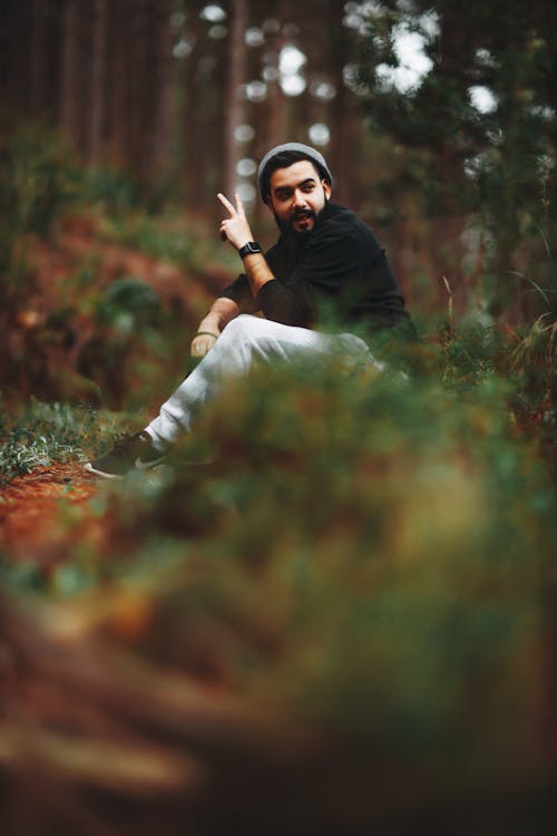 Free 

A Man Wearing a Black Sweater Sitting in a Forest Stock Photo