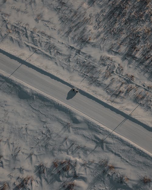 
An Aerial Shot of a Car on a Road during Winter