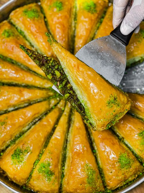 Free Delicious pistachio baklava captured in a vibrant, close-up vertical shot. Stock Photo