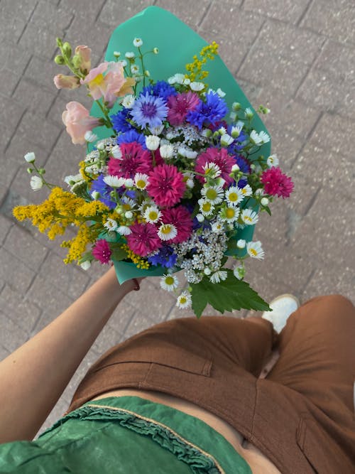 Free A Person Holding a Bouquet of Flowers Stock Photo