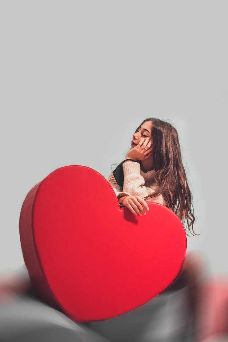 Woman Holding A Red Heart Shaped Box