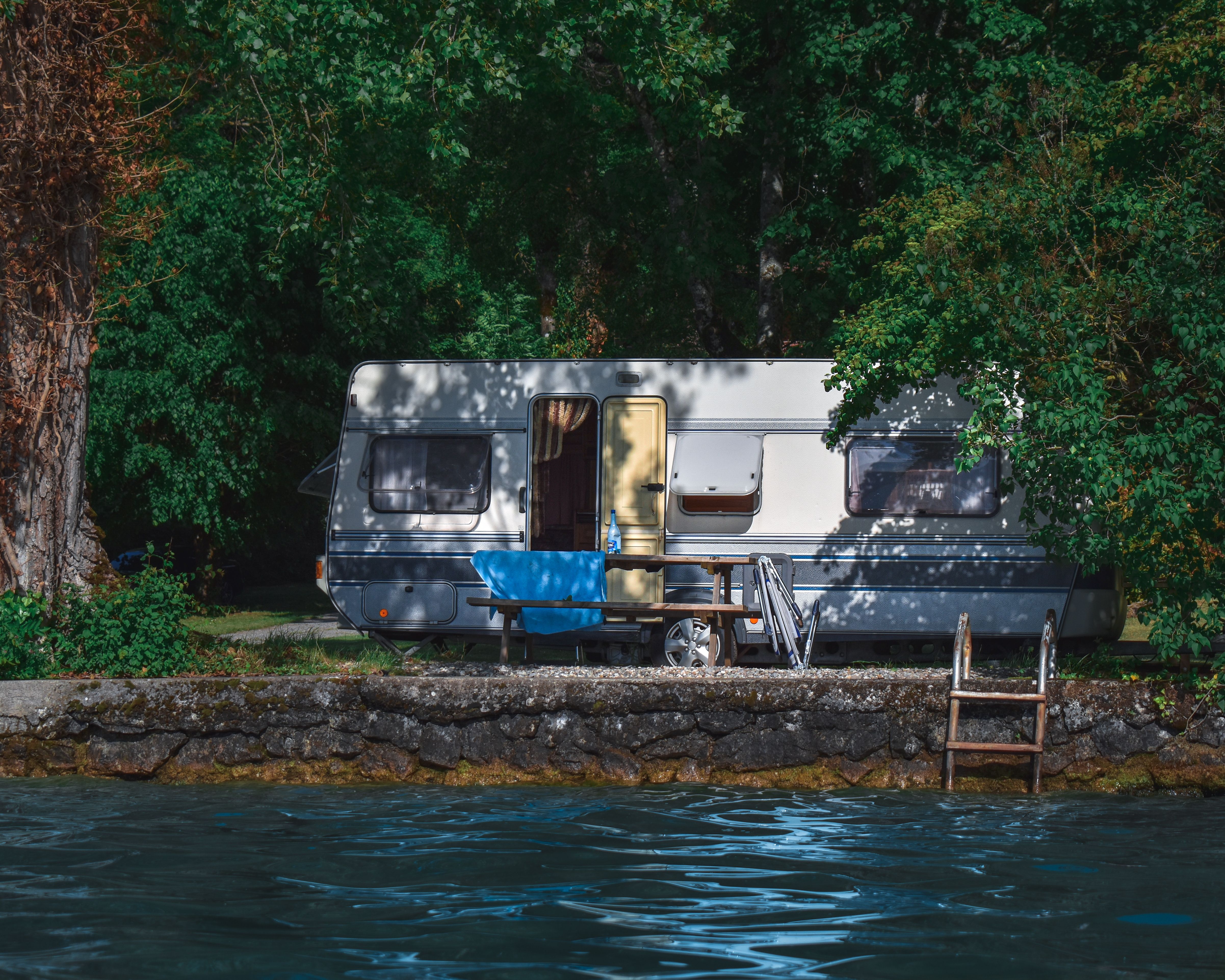 A Camper Van Parked Near a Lake · Free Stock Photo