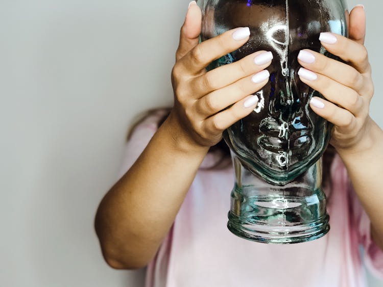 Person Holding Clear Glass Jar