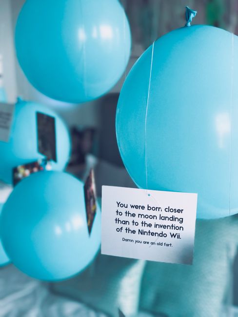 Pastel blue balloons with a humorous birthday card, perfect for a fun and festive celebration theme.