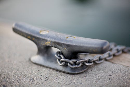 Black Metal Part With Metal Chain on Selective Focus Photo