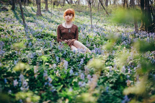 A Woman Sitting in a Flower Field