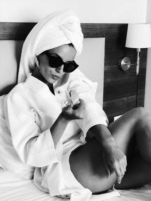 A Woman in White Bathrobe Wearing Sunglasses