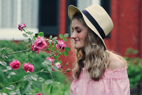Free Photo of Woman Smelling Flowers Stock Photo