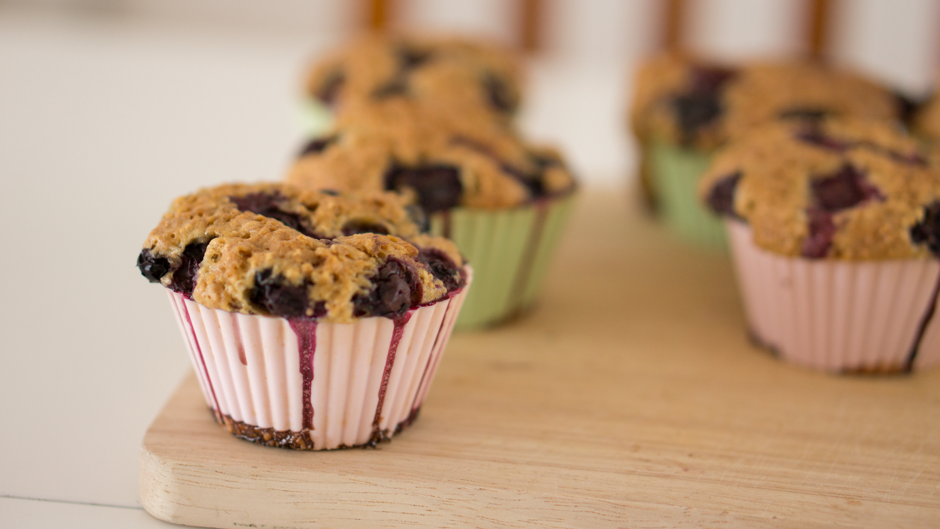 Blueberry cheesecake muffin fresh from the oven with soft crumb and streusel topping
