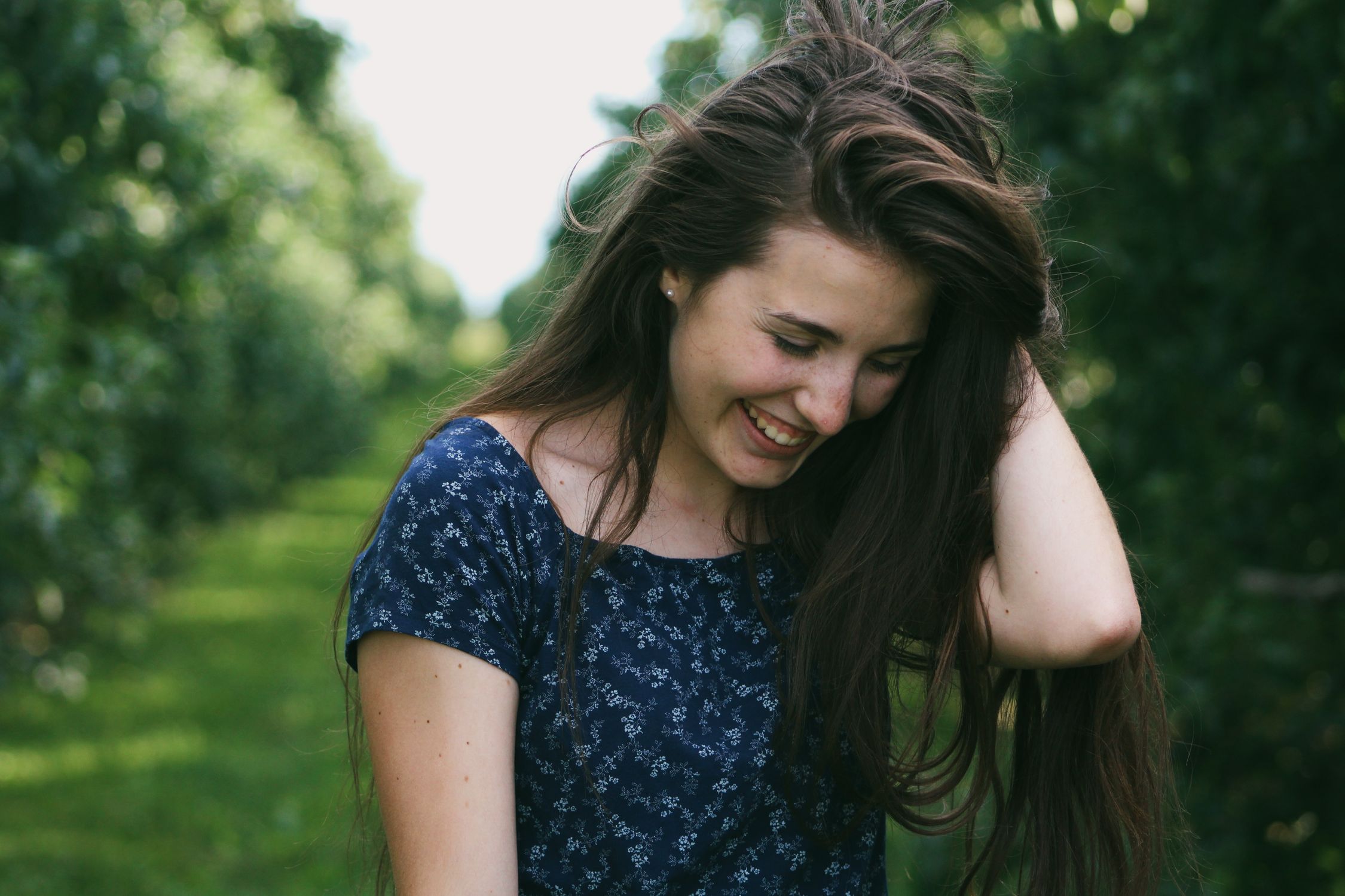 Photo of a Woman Holding Her Hair · Free Stock Photo