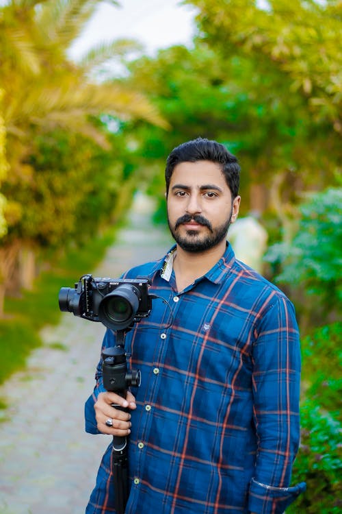 Portrait of a Photographer Holding a Camera