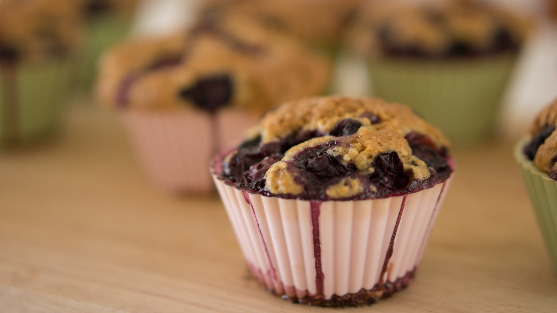 Close-up of a split gluten-free blueberry muffin showing creamy cheese filling