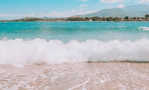 Free A picturesque scene of waves crashing on the beach at Governor Generoso, Philippines. Stock Photo
