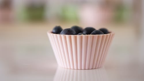 Selective Focus Photography of Grapes on White Container