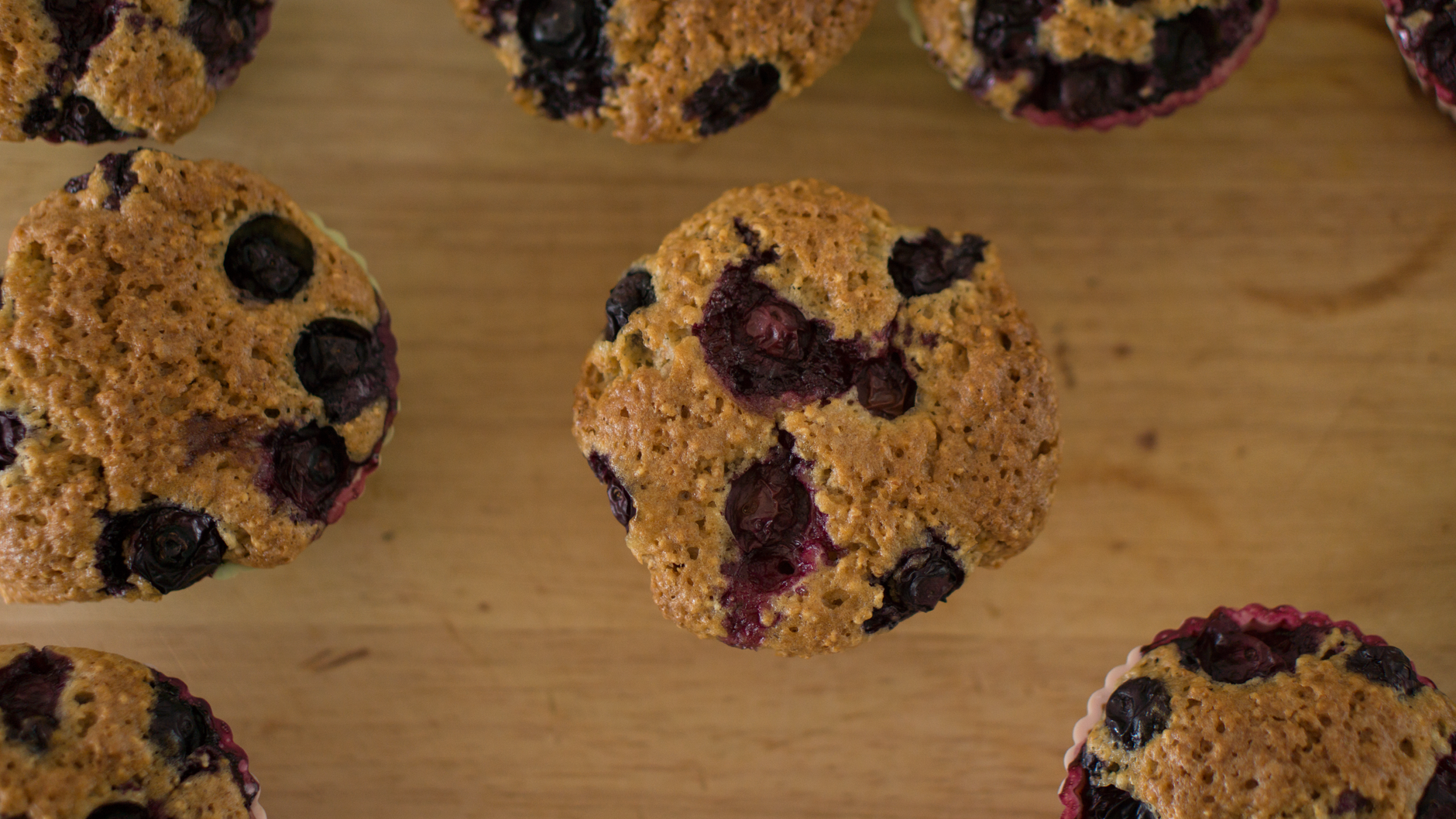 Keto blueberry muffin cut open showing moist crumb and blueberries up close