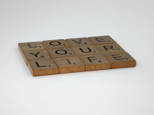 Brown Wooden Scrabble Tiles on White Background