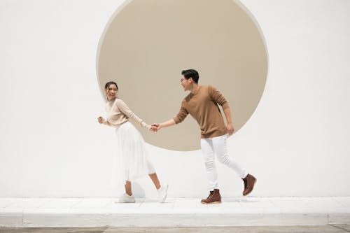 Free Man and Woman Dancing on White Platform Stock Photo