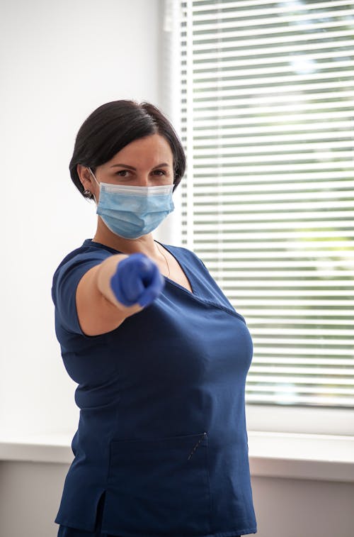 Woman in Blue Scrub Suit Wearing Face Mask