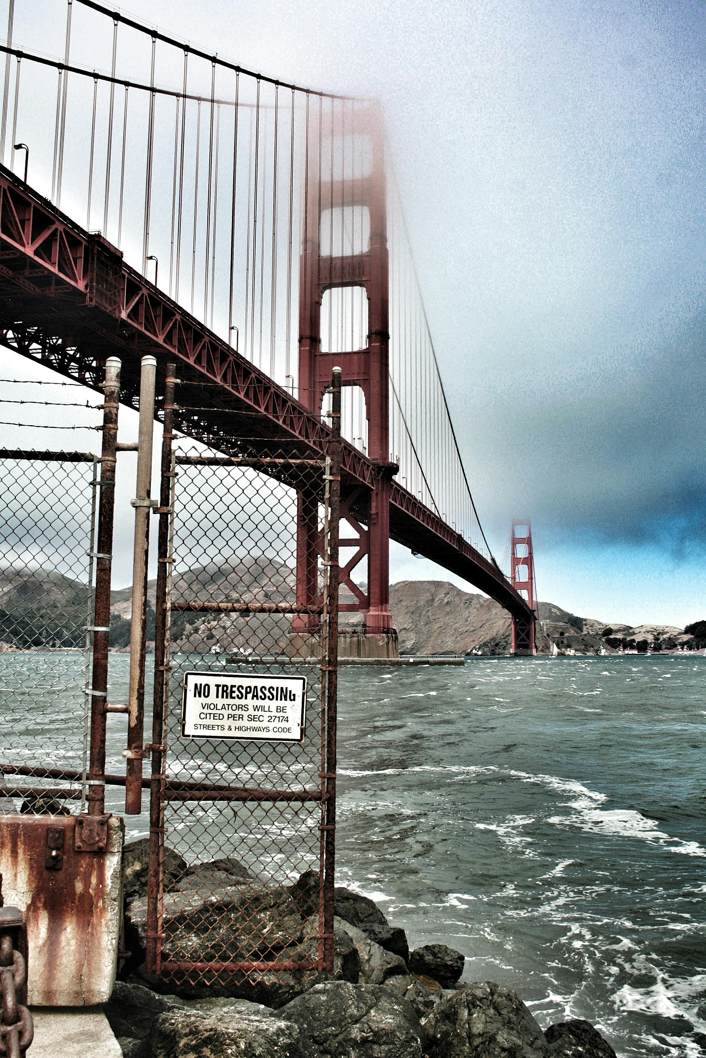 Red Metal Bridge on White Under White Clouds during Daytime