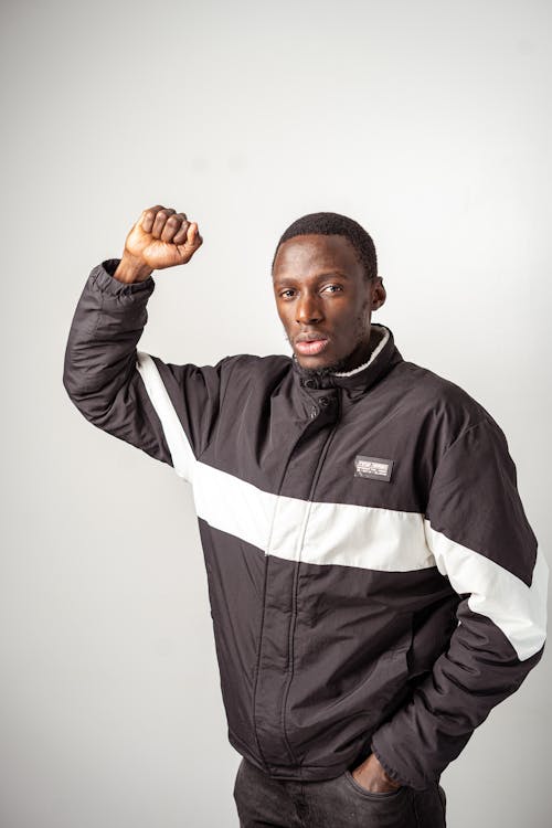 Free Man in Black Jacket with his Fist Up  Stock Photo