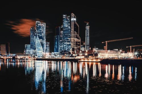 Free Stunning view of Moscow City skyline reflecting on the waterfront during nighttime. Stock Photo