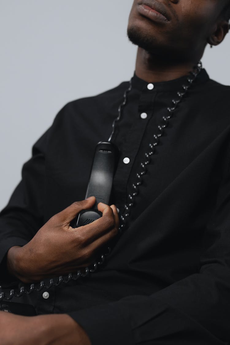 A Man Holding A Telephone