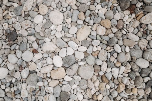 Free High-resolution image of a natural pebble stone texture ideal for backgrounds or wallpapers. Stock Photo