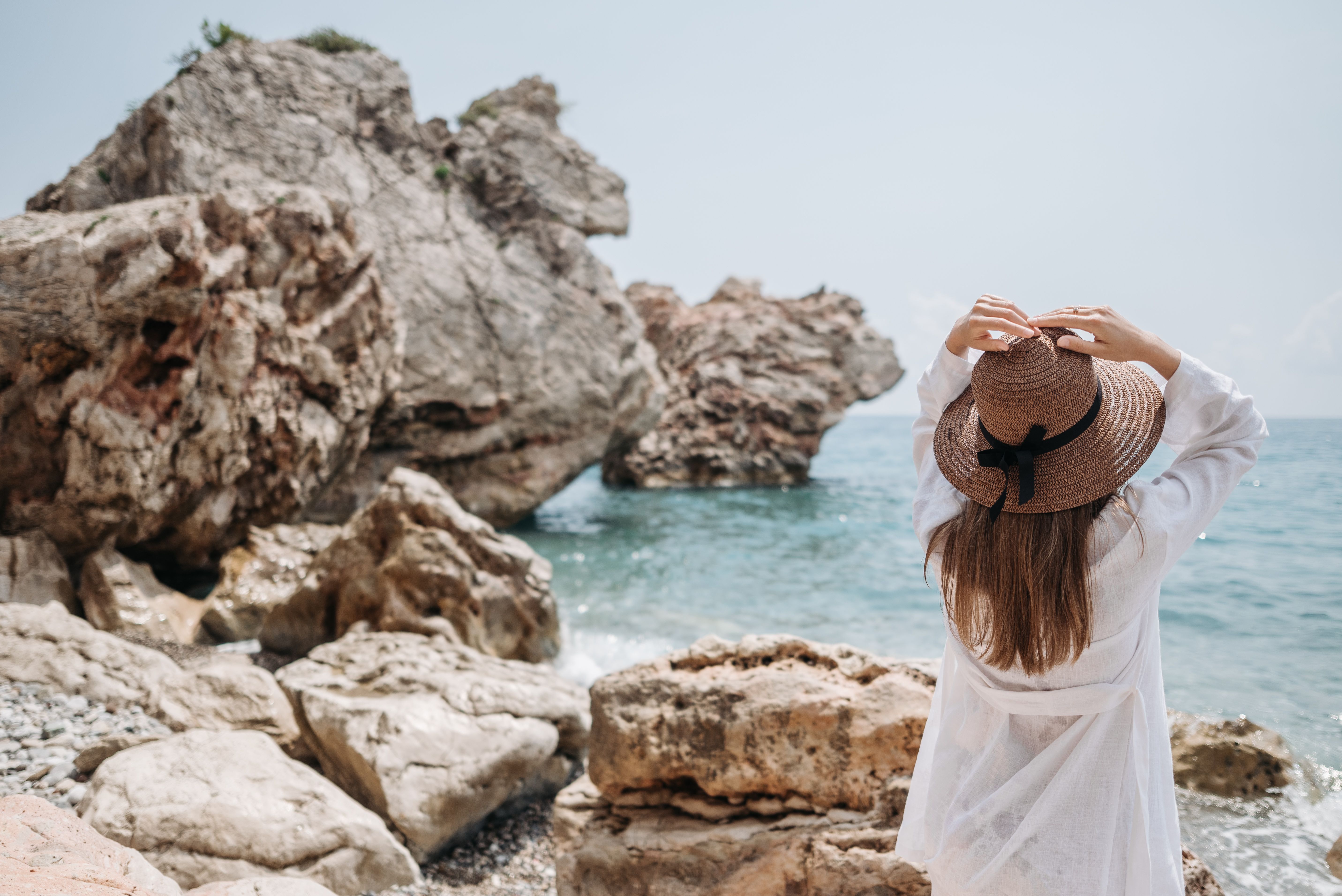 A Woman in White Long Sleeve Shirt Standing on the Shore · Free Stock Photo