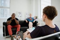 A Bald Man and a Woman Sitting on a Sofa