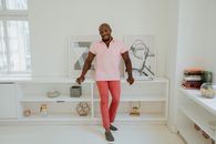 Woman in White Polo Shirt and Pink Pants Standing on White Ceramic Sink