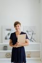 Woman in Black Shirt Holding White Book