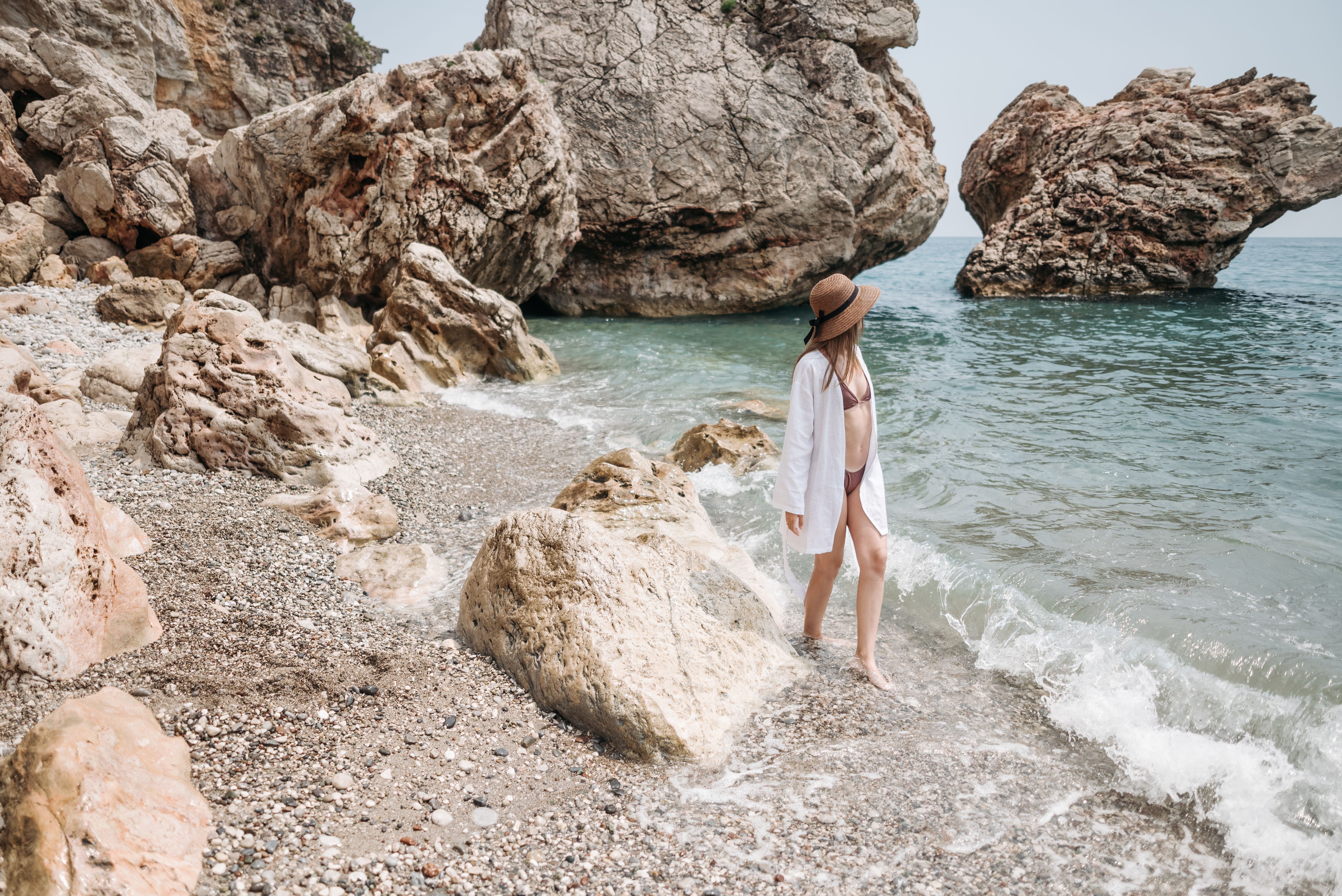 Woman in Swimsuit Standing on Beach Shore · Free Stock Photo