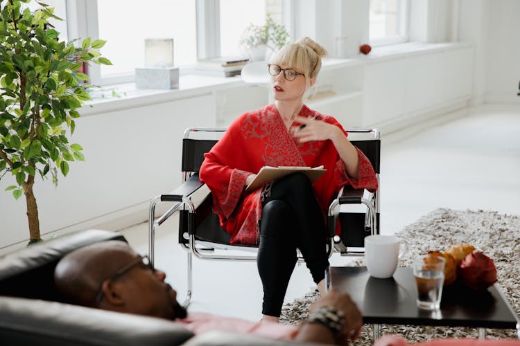 Man Lying On A Sofa And Talking To A Psychologist 